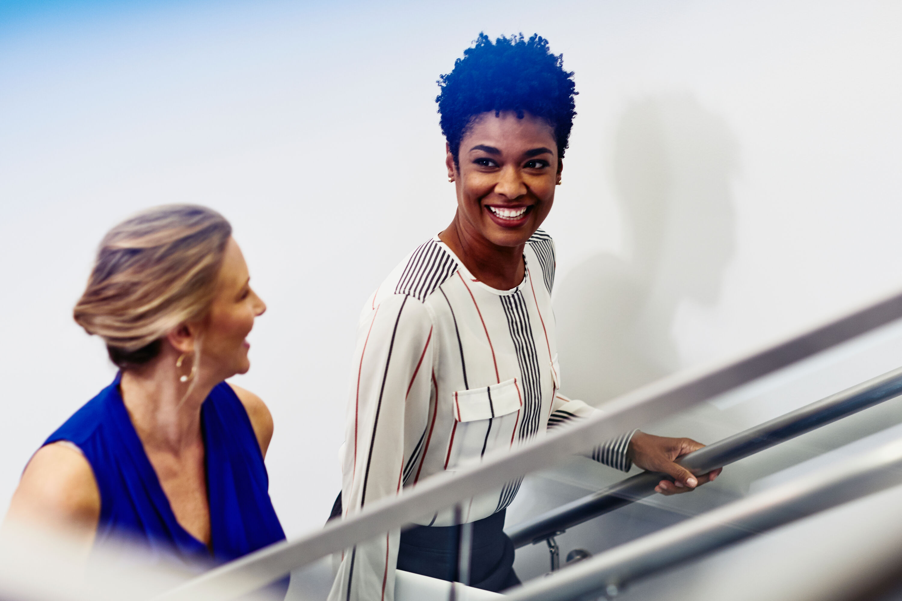 two people talking walking up the stairs about recruitment