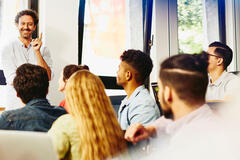 Male teacher smiling in classroom