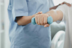 A nurse helping a patient