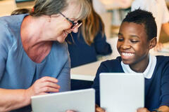 Female teacher helping an SEN secondary student.