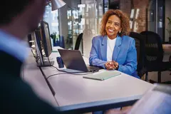 A lady is sitting in the office