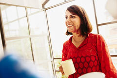 woman talking while smiling and consideringofostering