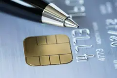 Close up of a pen on platinum credit card.