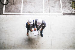 top view of two engineers with clipboard