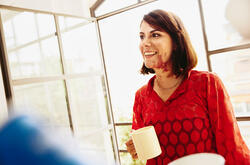 woman talking while smiling and consideringofostering