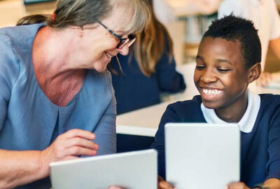 Female teacher helping an SEN secondary student.