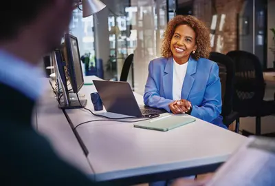 A lady is sitting in the office