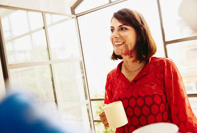 woman talking while smiling and consideringofostering