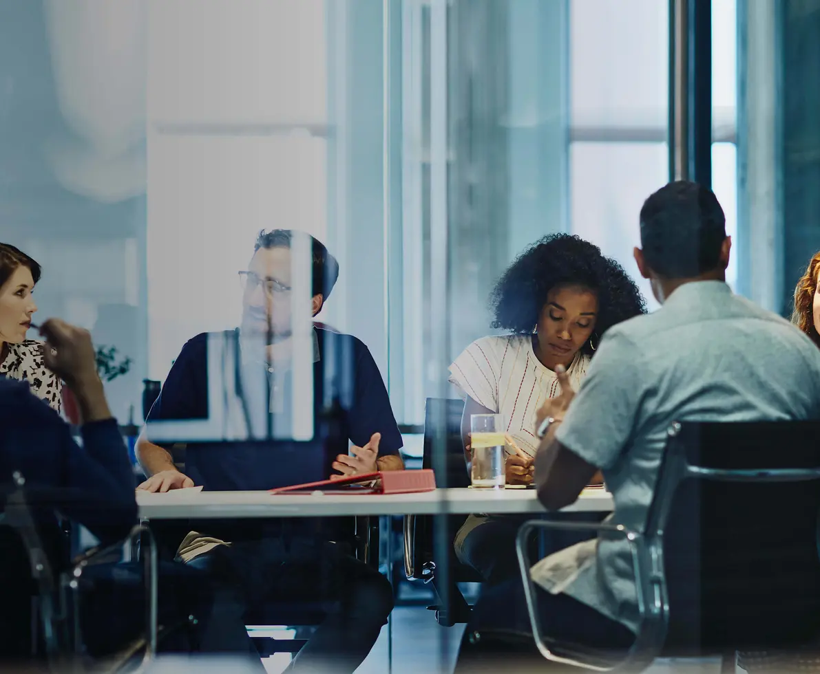 people working in an office boardroom