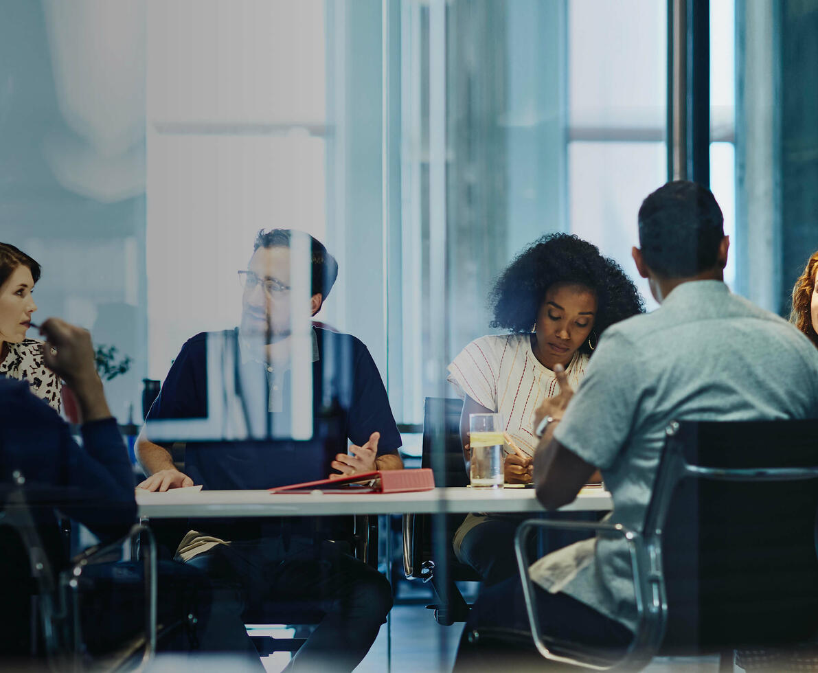 people working in an office boardroom