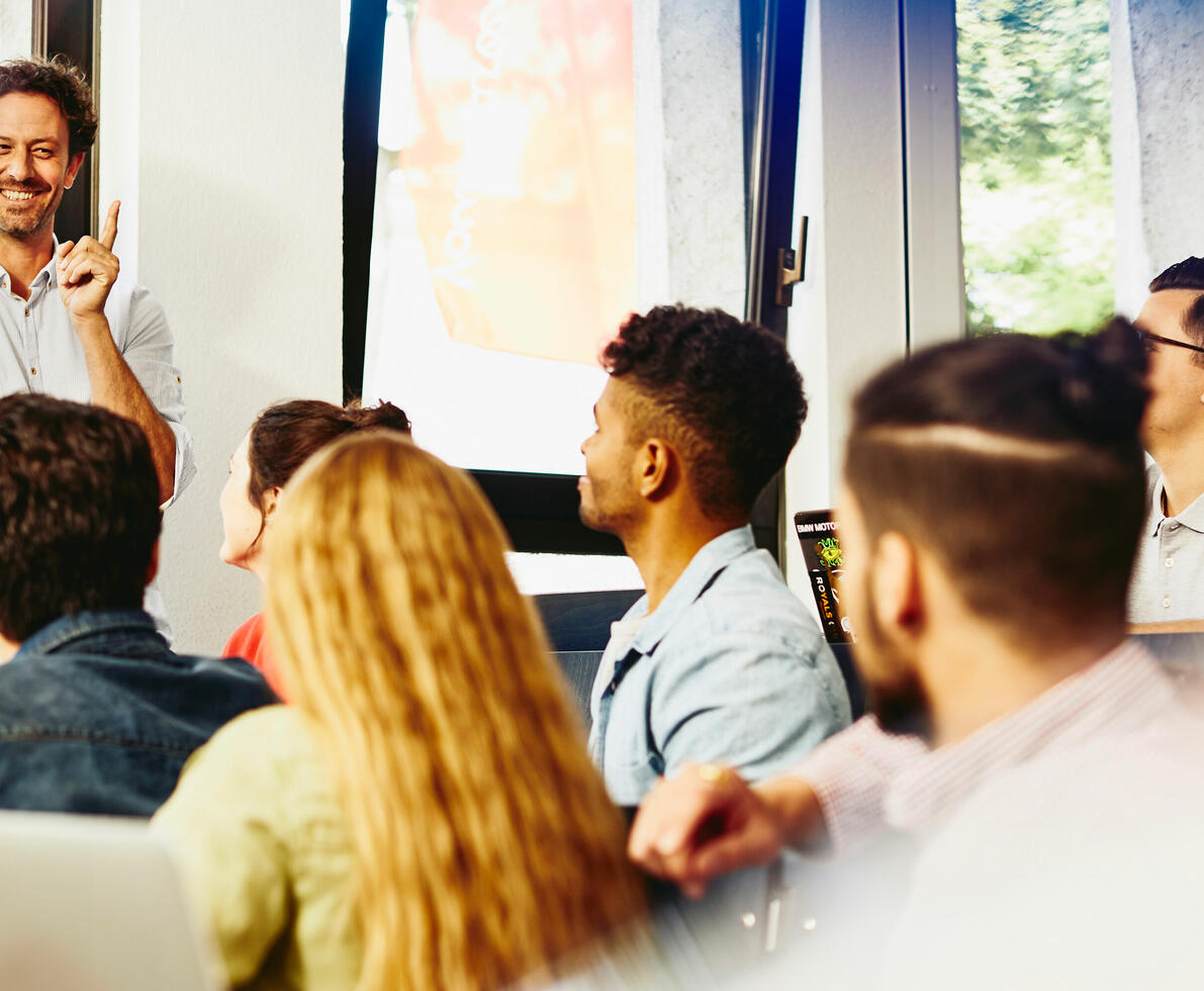 Male teacher smiling in classroom