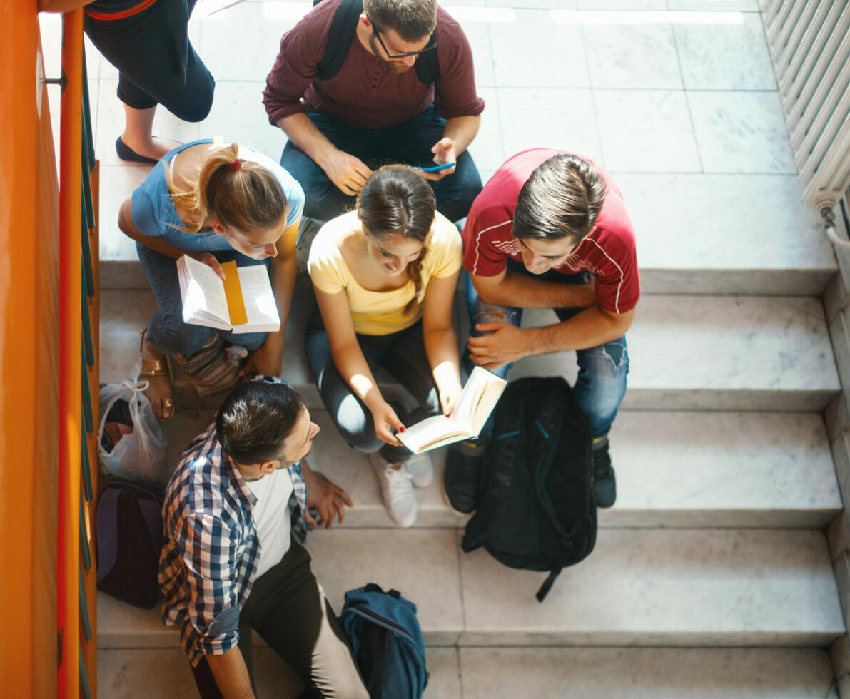 pupils sitting in a corridor