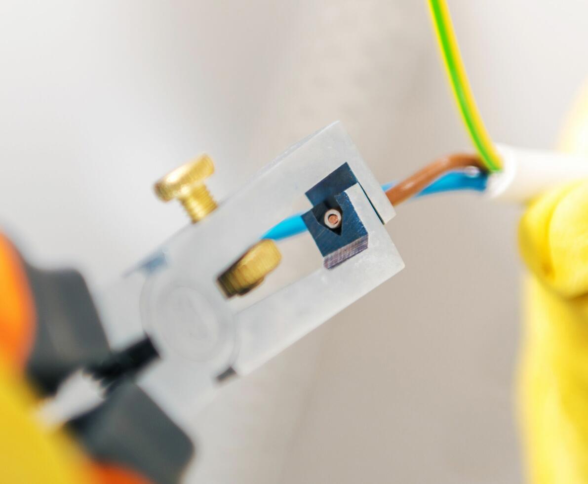Preparing cables for the outlet installation. Electrician job.