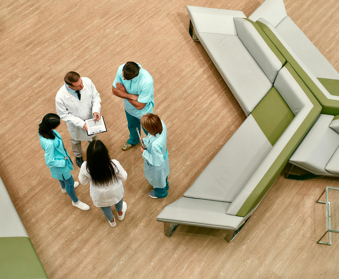 Doctors and nurses in conversation in a lobby