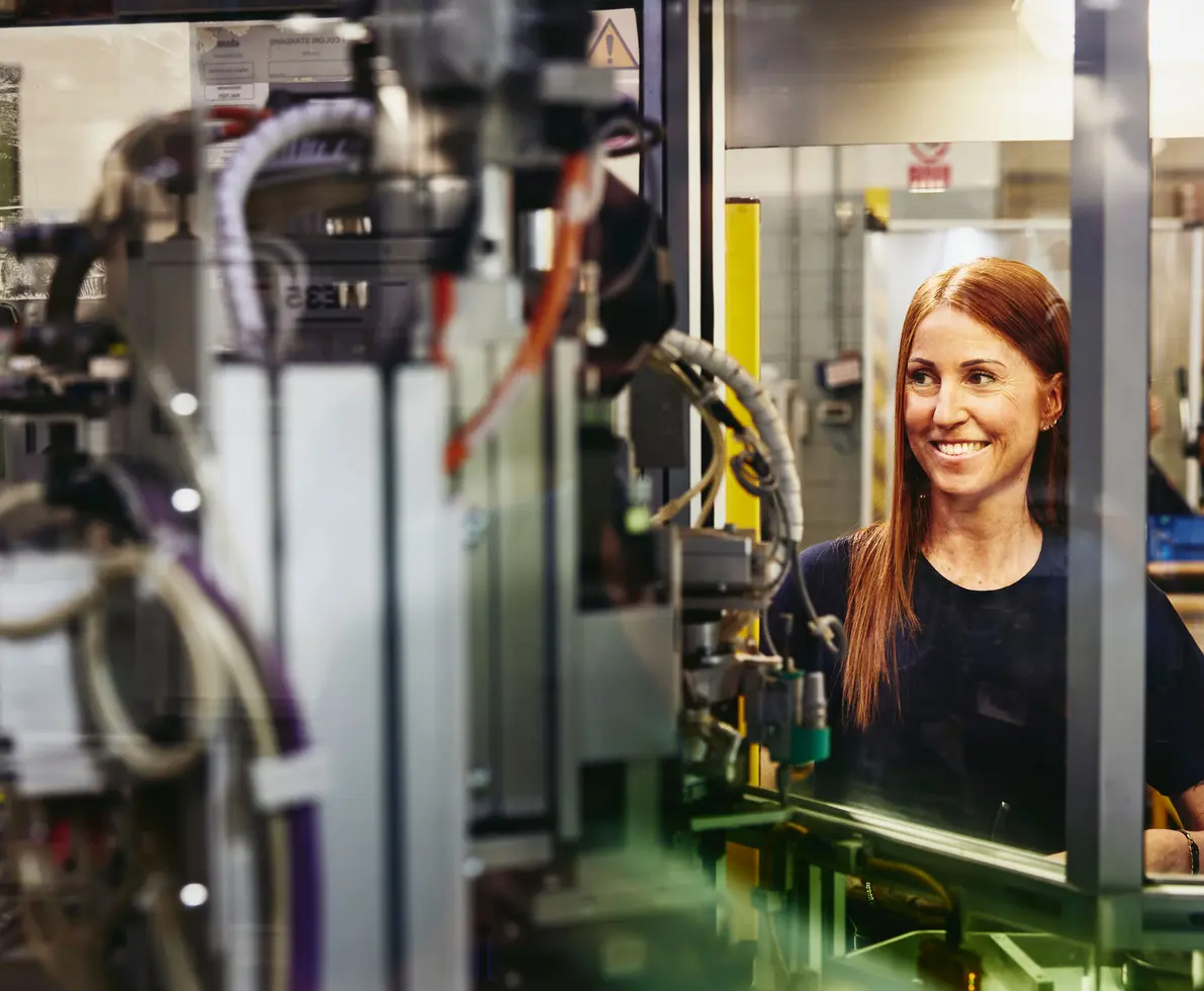 Woman operating a machine on a production site.