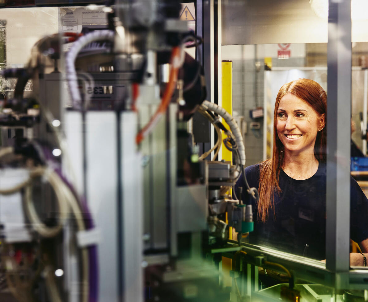 Woman operating a machine on a production site.