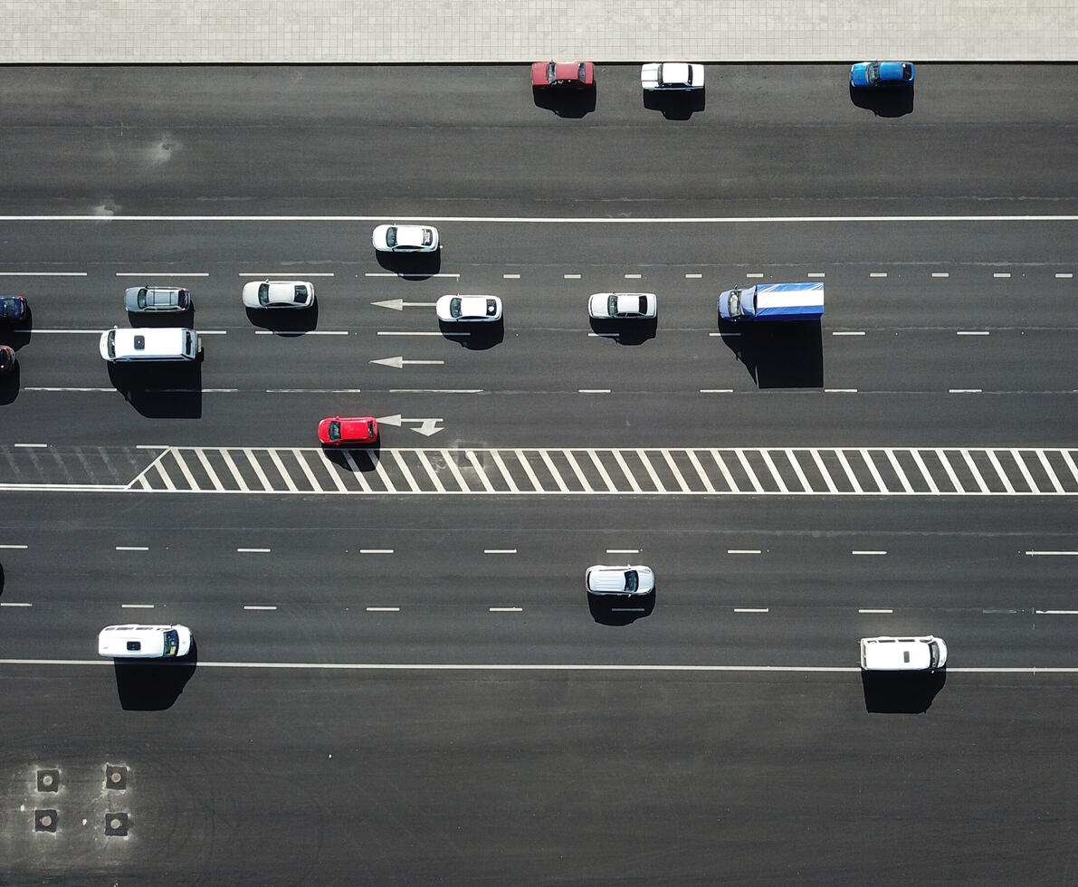 Aerial view shot of traffic on the road on sunny day.