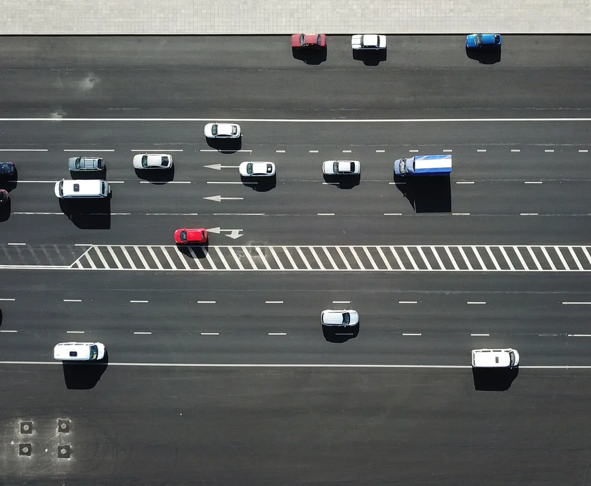 Aerial view shot of traffic on the road on sunny day.