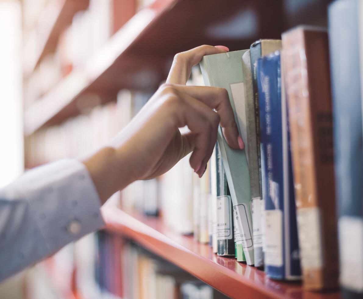 student picking up a book