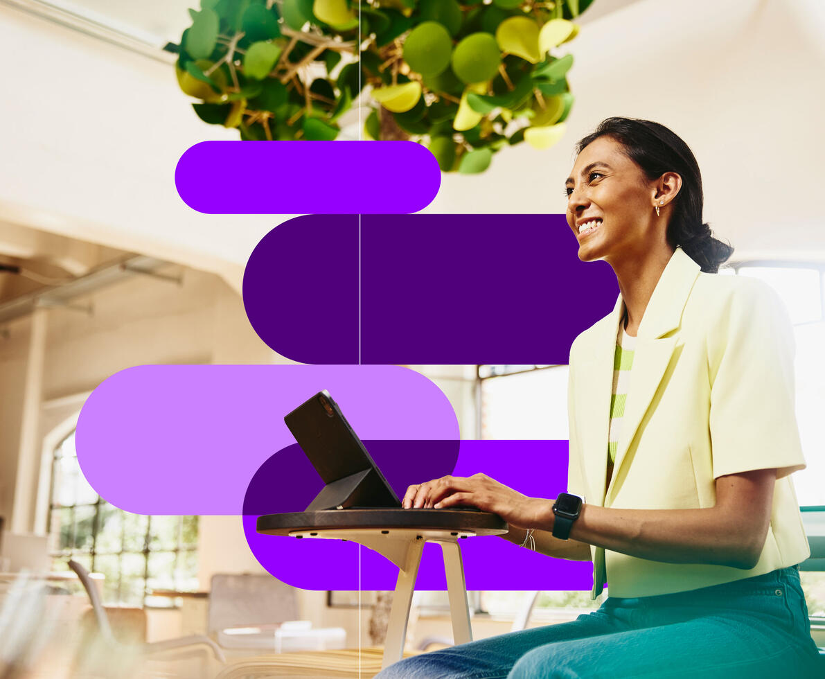 image of a woman on a laptop with randstad branding behind her