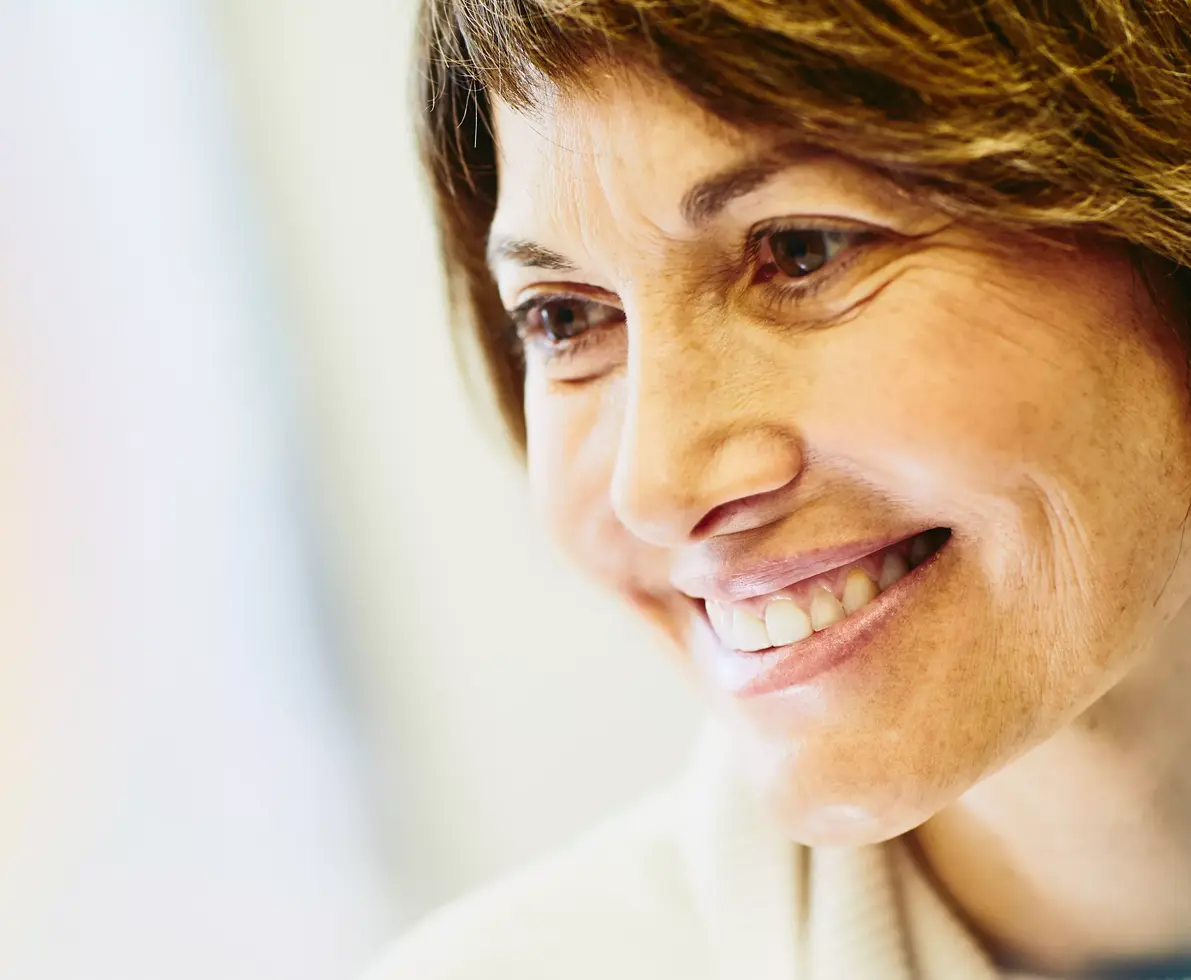 A smiling women dealing with her inner struggles.