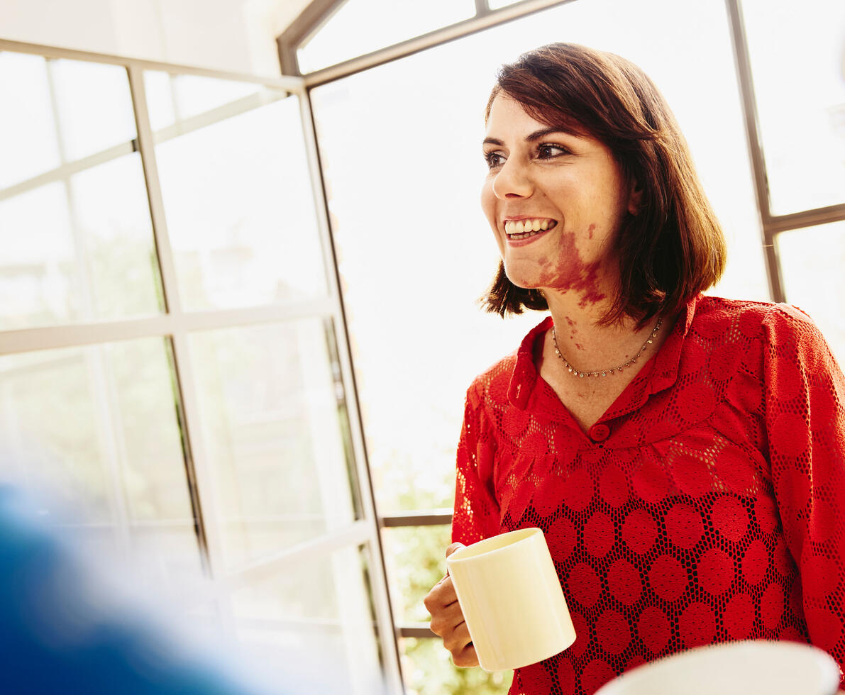 friendly person holding a cup of coffee