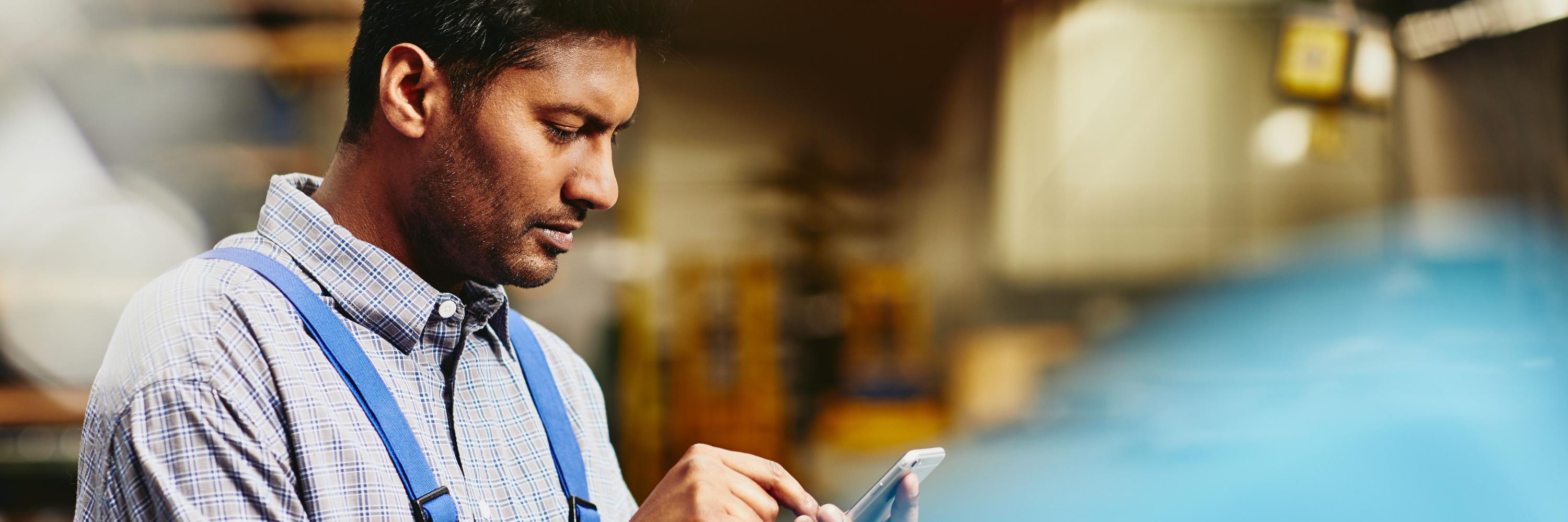 Image of man looking at phone