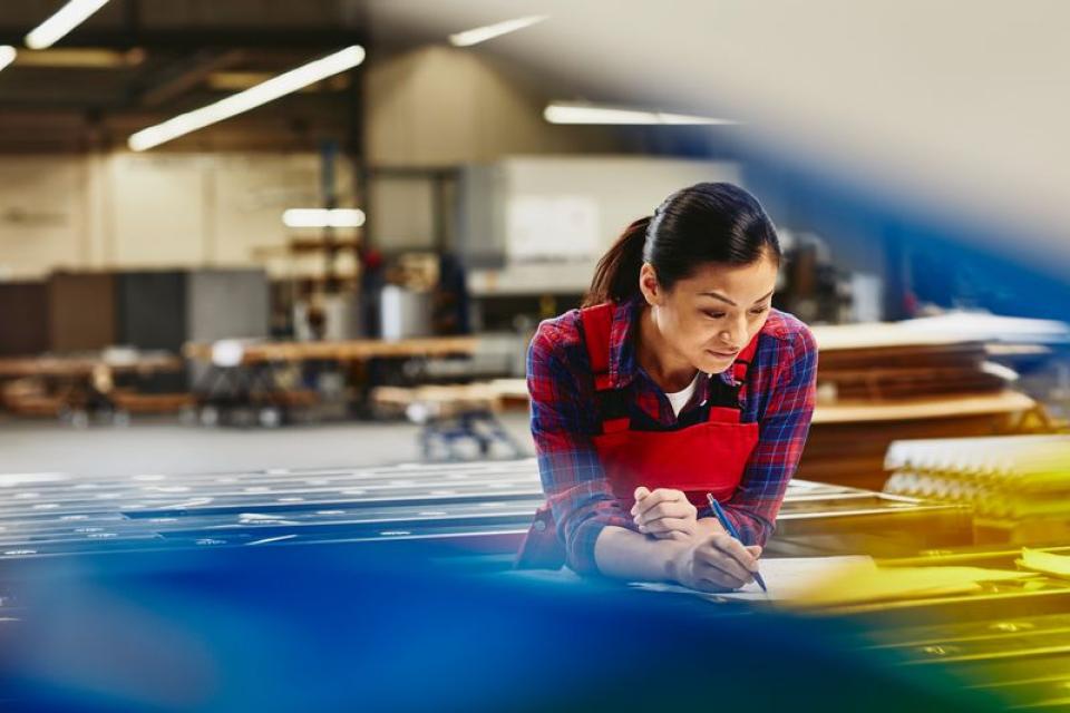 Woman working in manufacturing environment or factory