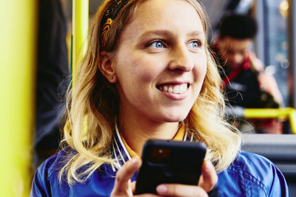 Woman on bus using phone