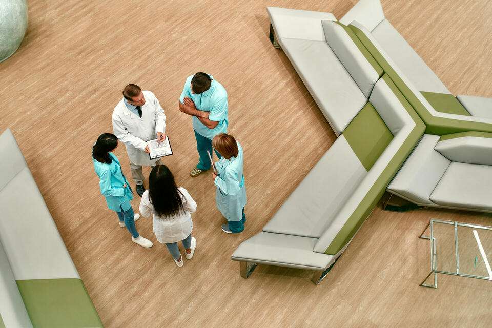 Doctors and nurses in conversation in a lobby