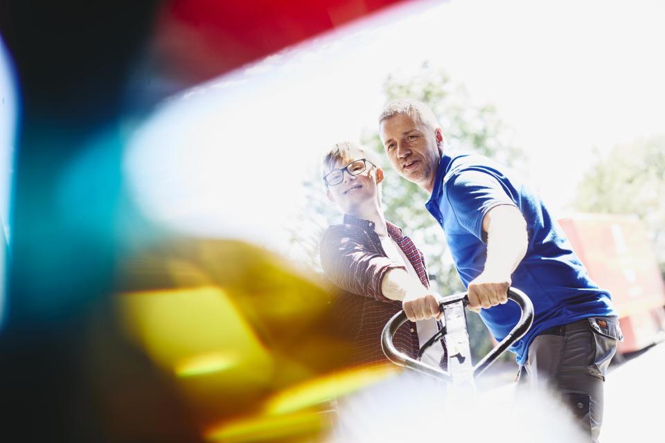 two people pulling a trolley